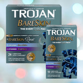 Image of two boxes from the Trojan Bareskin EveryTHIN Pack by Trojan on a blurred background. The larger box includes 24 condoms with mixed varieties: Bareskin Raw, Original Bareskin, and Studded Bareskin. The smaller box contains 10 Ultra Thin Condoms designed for a more natural experience.